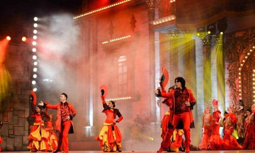 Spanish Performers on stage performing in front of an audience in Spain.